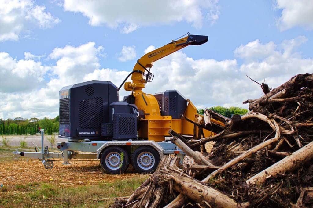ARB Max F30 wood chipper behind log pile