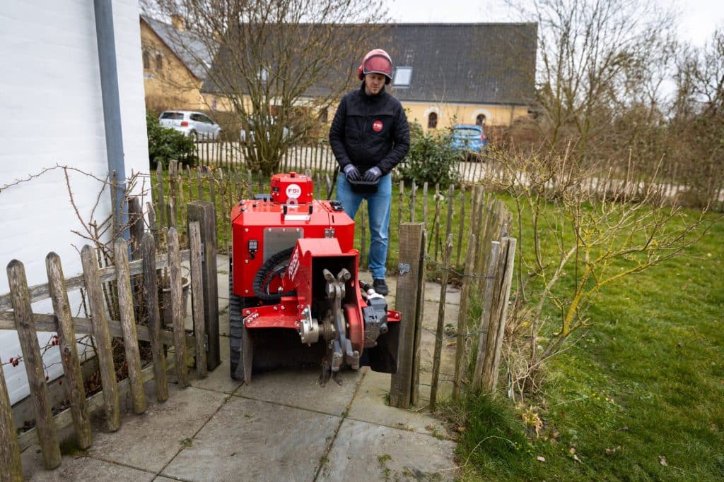 FSI B31-980 Remote stump grinder passing through a narrow garden gate demonstrating 740mm width