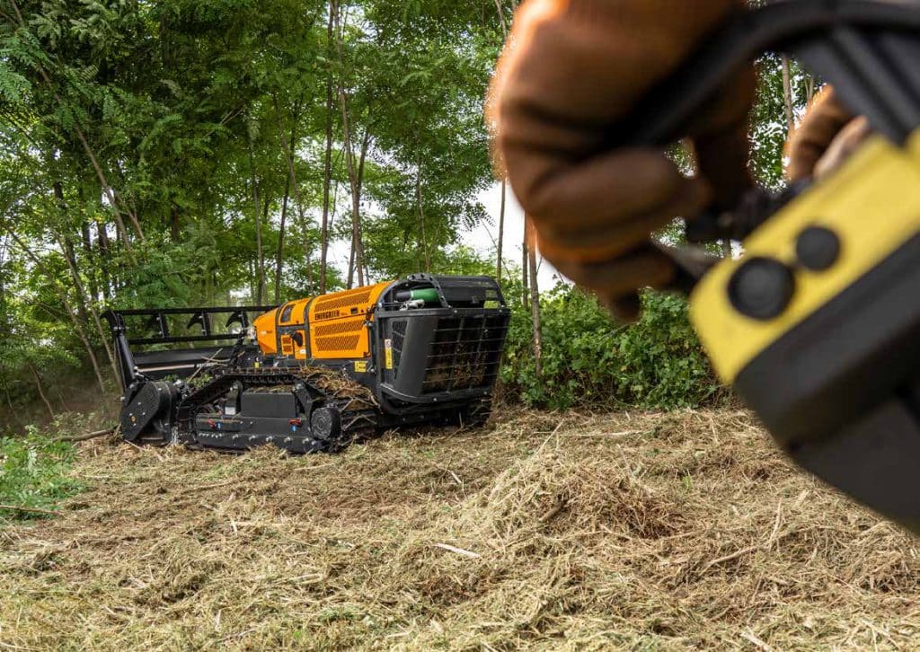 Operator controlling Energreen RoboPlus via Autec remote control in the field
