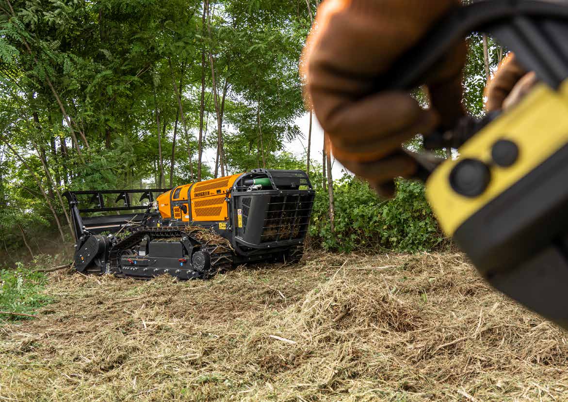Operator controlling Energreen RoboPlus via Autec remote control in the field