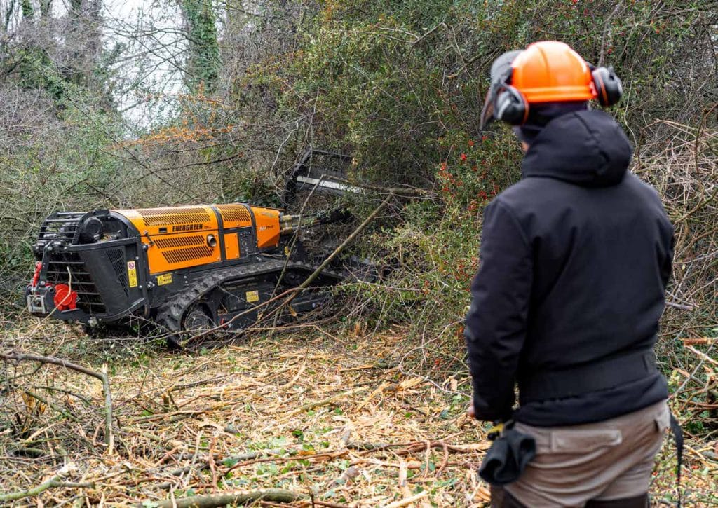 Energreen RoboPlus orange and black tracked robot working in a dense forest environment
